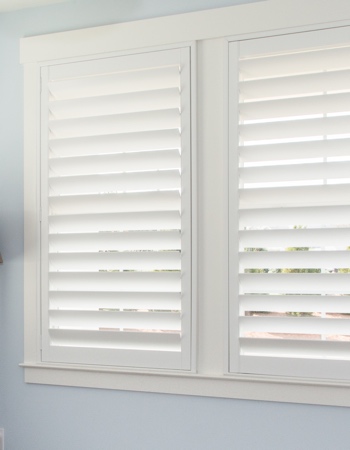 White plantation shutters with hidden tilt rods in Denver